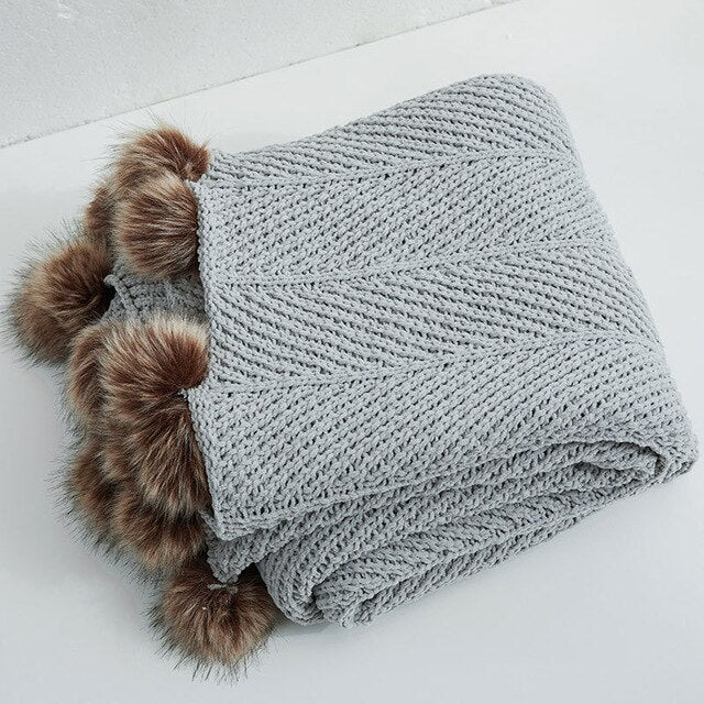 Grey knitted throw with pom online poms